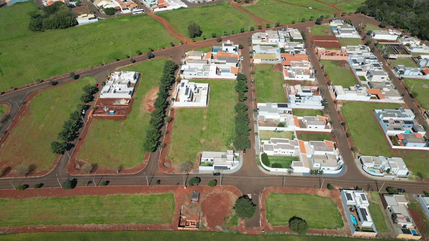 Vista aérea de rua arborizada do loteamento Cidade Nova com casas já construídas